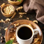 Mushroom coffee in a cup and coffee beans, trendy drink.
