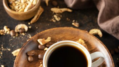 Mushroom coffee in a cup and coffee beans, trendy drink.
